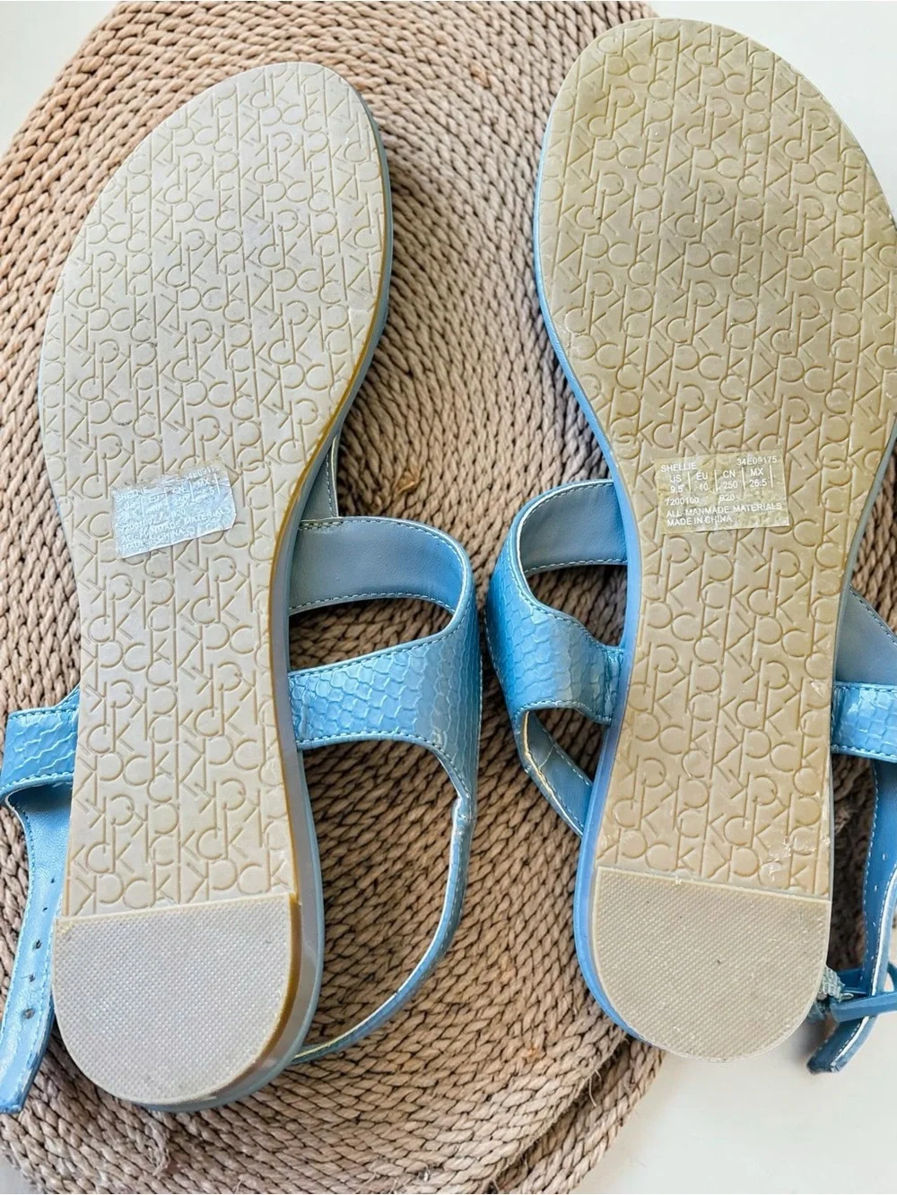 Calvin Klein Shellie blue snake print flat thong sandals feature an ankle strap